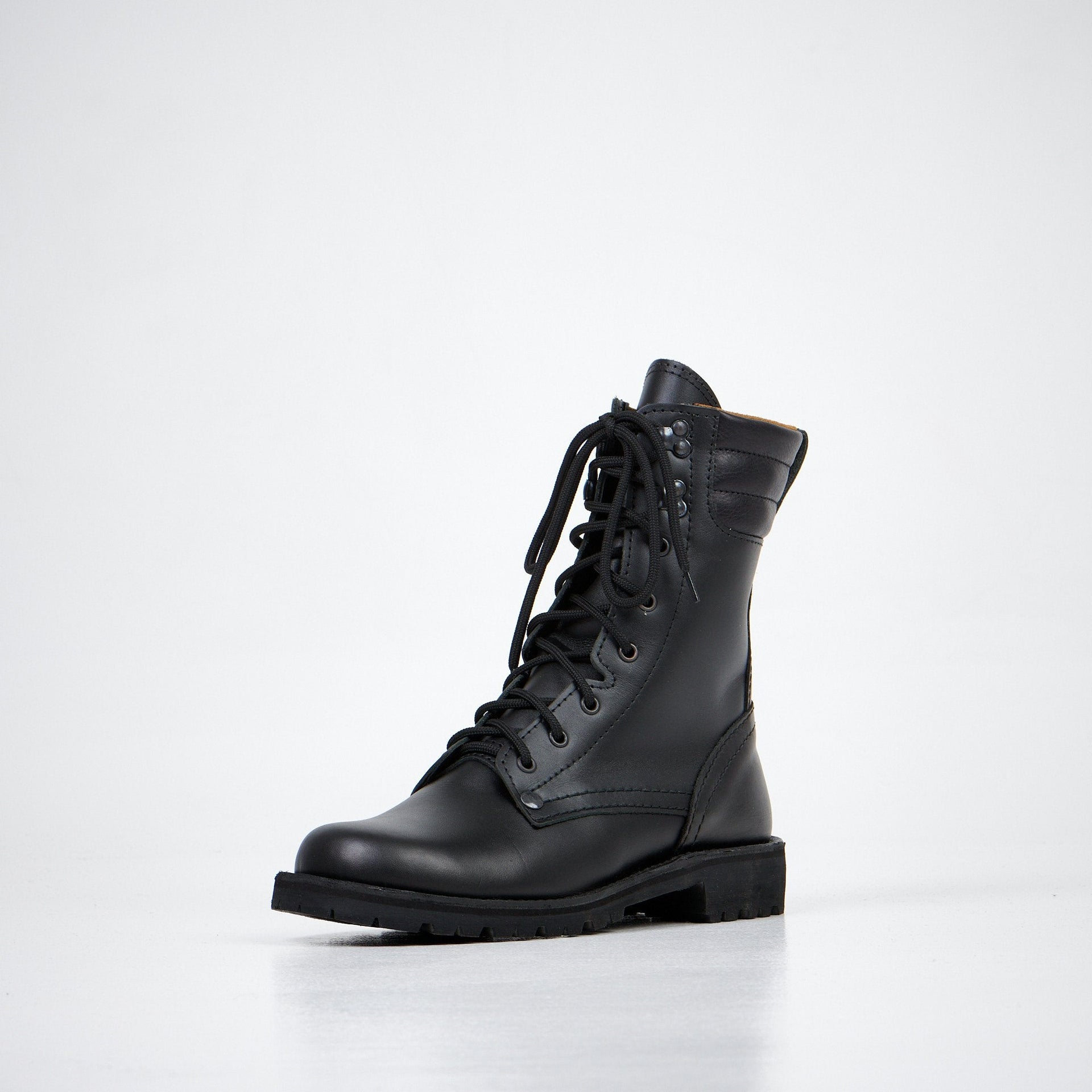 1. Aipi AIPI-1 handmade leather boots in black, shown in a studio setting with side view highlighting durable rubber sole and lace-up design