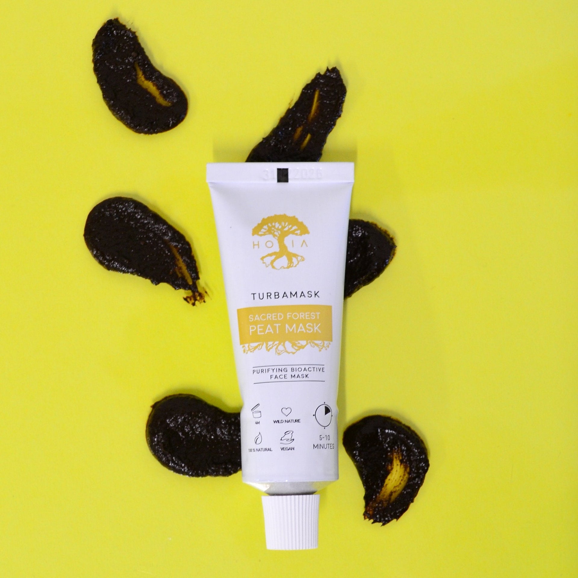 1. HOIA homespa Sacred Forest Peat Mask tube on yellow background with peat swatches, highlighting natural skincare