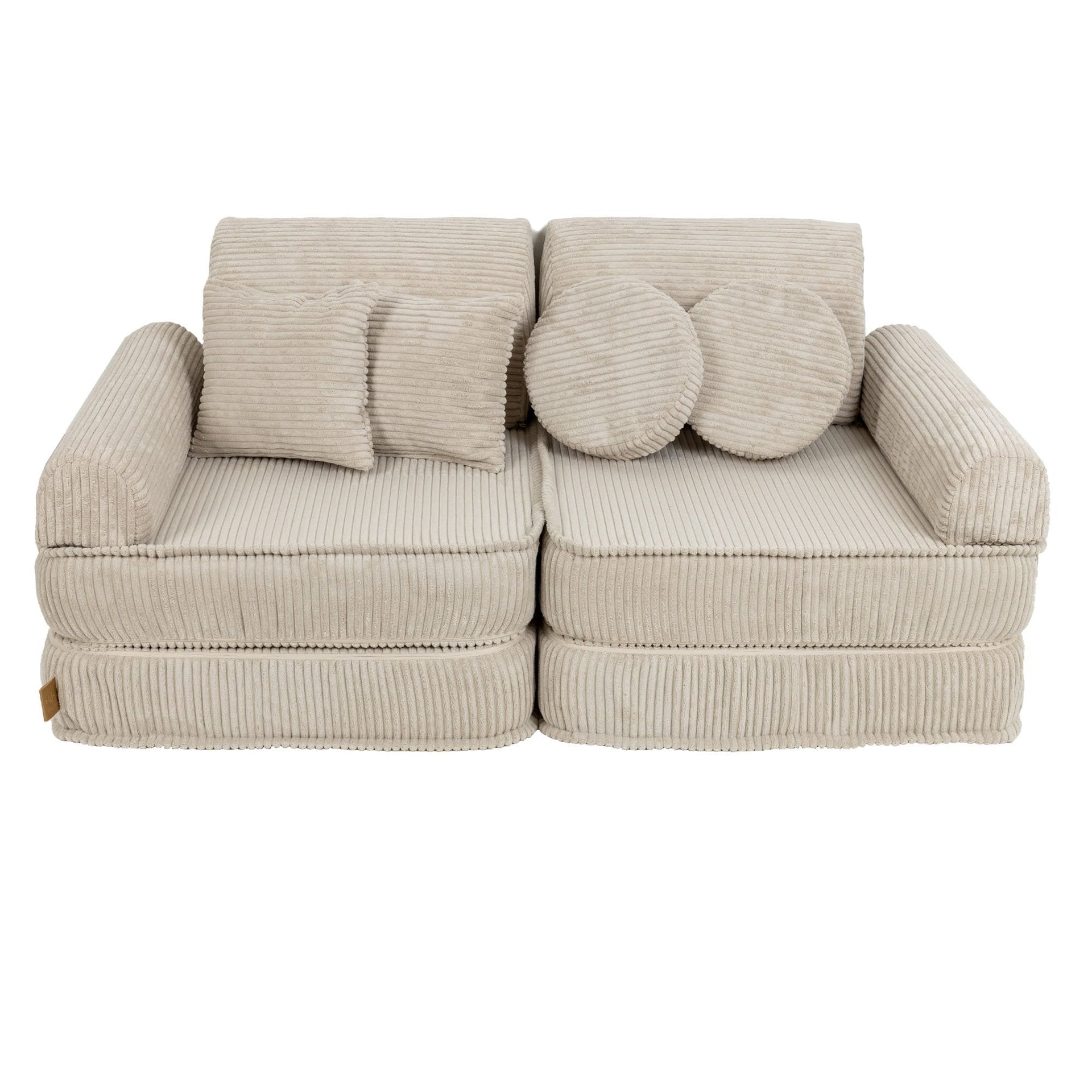 1. Children's modular sofa in aesthetic ecru with ribbed texture, featuring two back cushions and two round pillows, shown in a studio setting