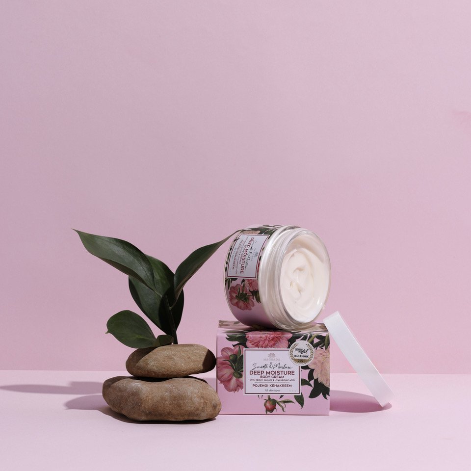 1. Magrada Organic Cosmetics Peony Body Cream with Quince Extract in open jar on pink background with stones and plant