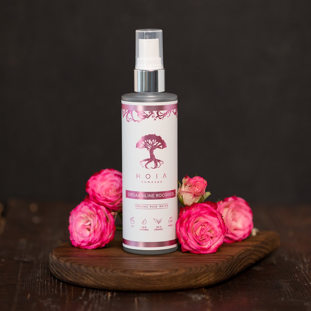 1. HOIA homespa Organic Rose Water 100ML bottle with pink roses on wooden surface