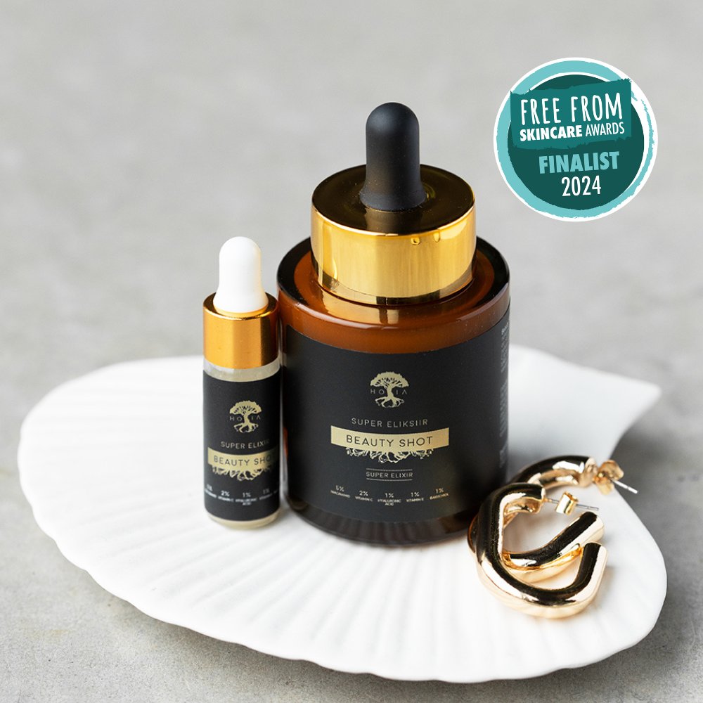 1. HOIA homespa Beauty SHOT Serum 30ml with dropper, displayed on a shell with gold earrings, featuring 'Free From Skincare Awards Finalist 2024' badge