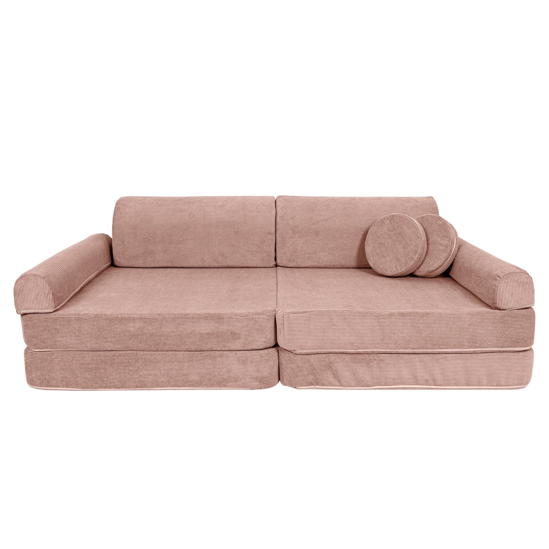 1. Large pink modular sofa for kids in slimcord corduroy with two round cushions, shown in a studio setting