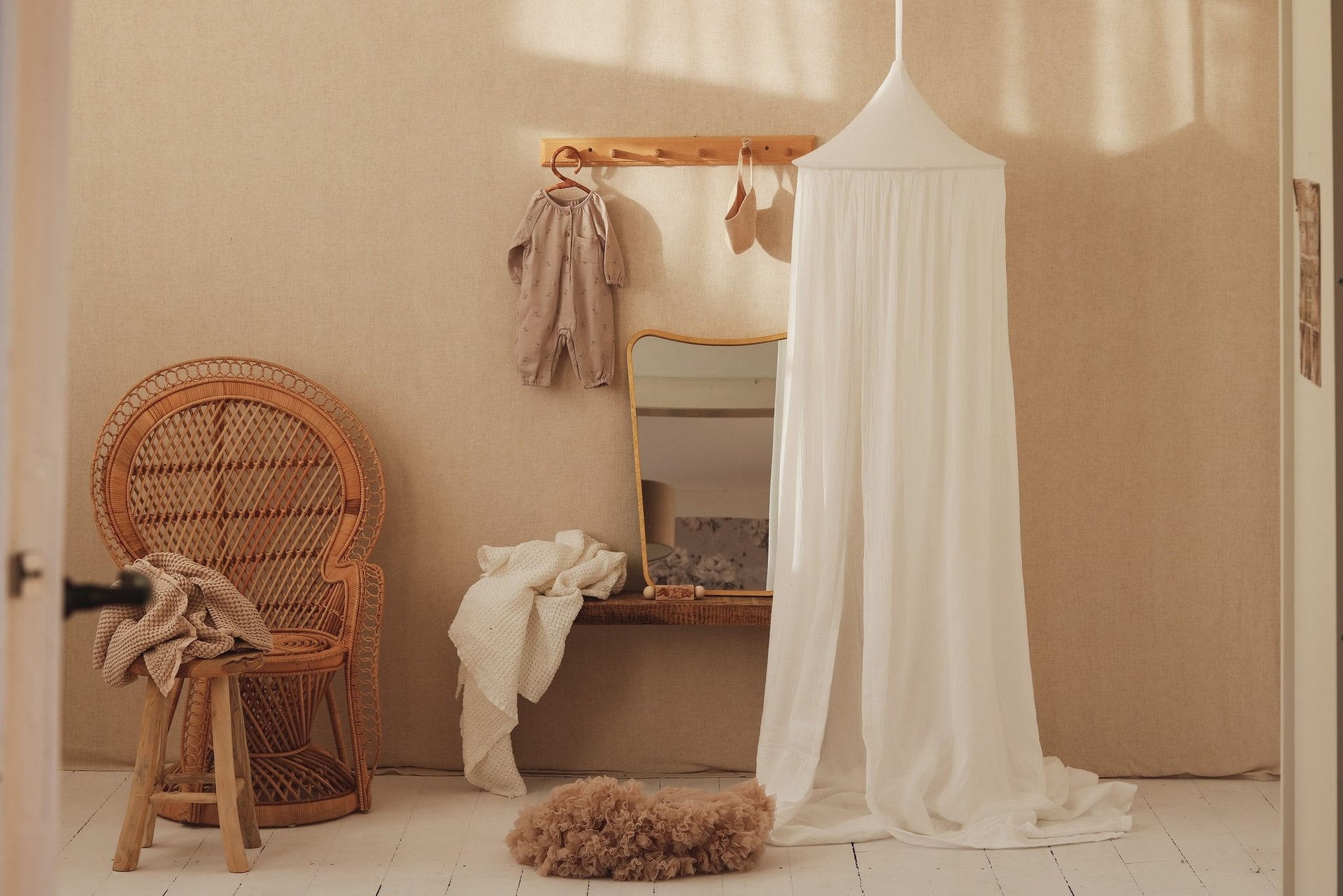 1. Cream cotton canopy hanging in a cozy room with wicker chair and mirror, creating a serene reading nook