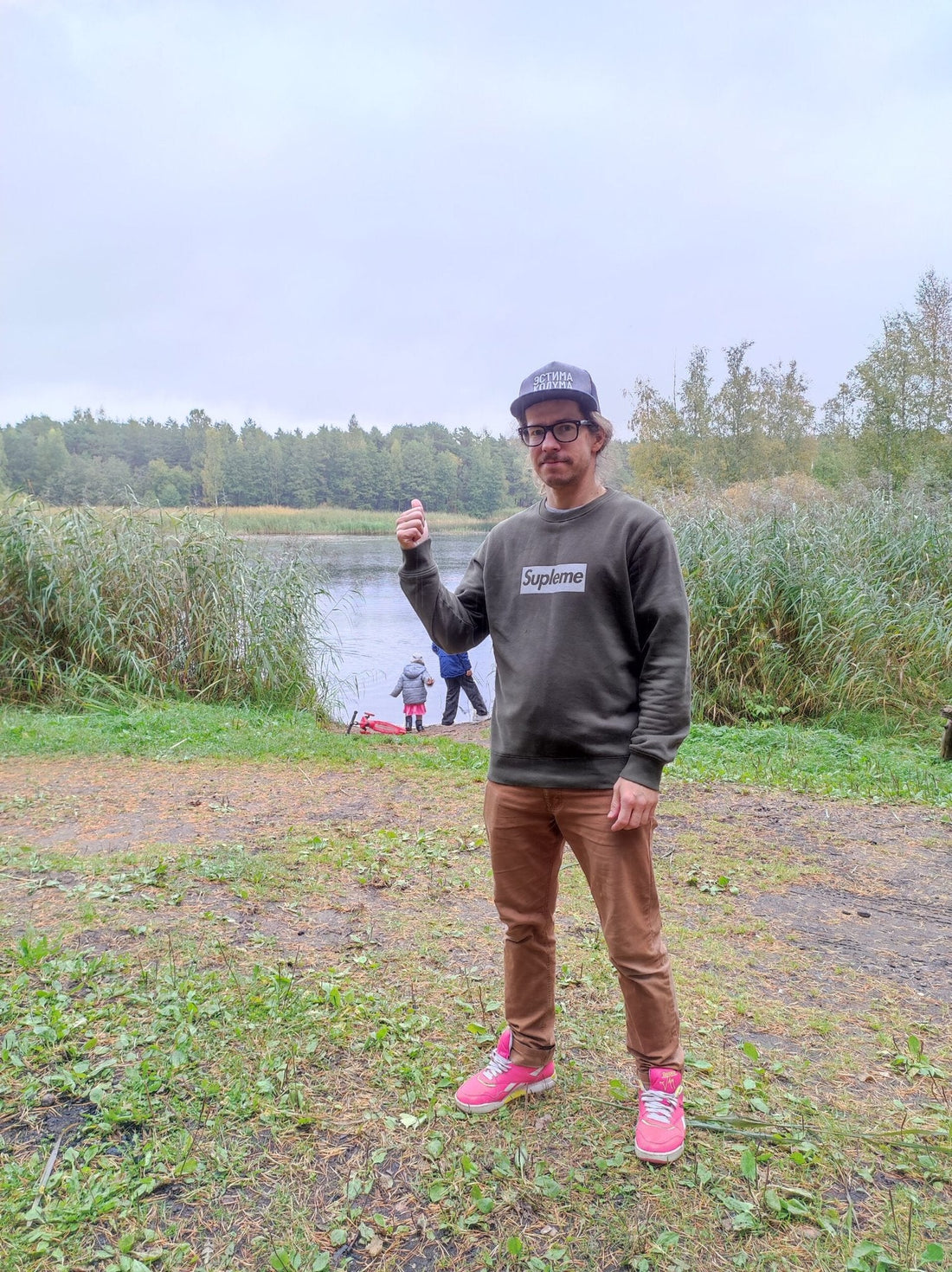 1. Men's khaki Supleme sweatshirt by Heavy Mental worn outdoors, showcasing casual style