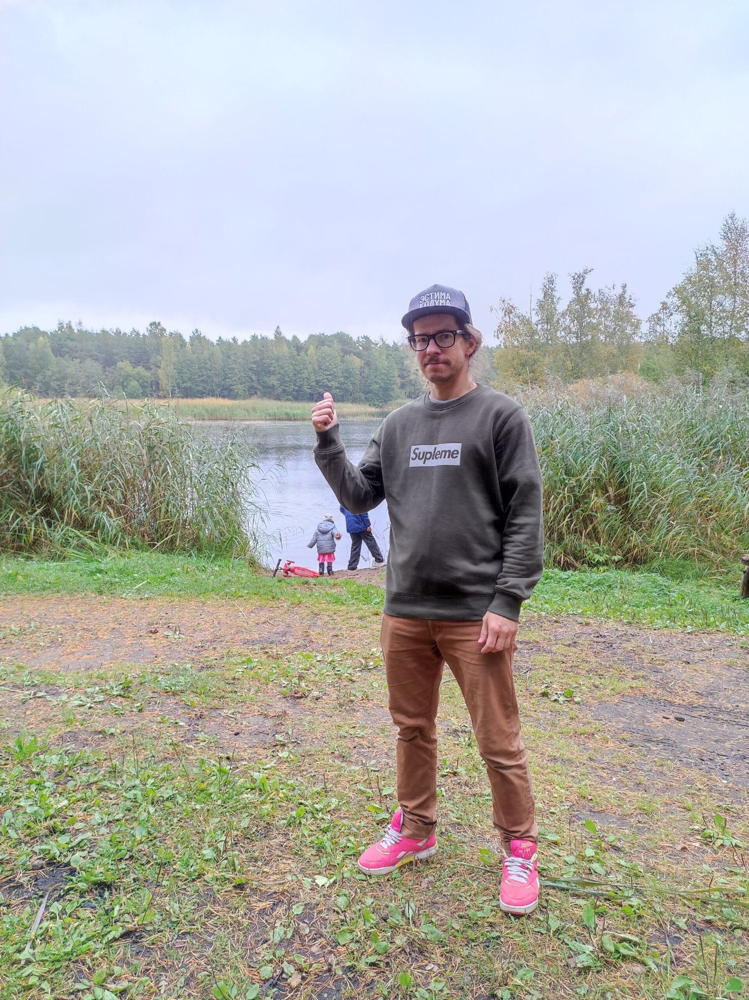 1. Men's khaki Supleme sweatshirt by Heavy Mental worn outdoors, showcasing casual style