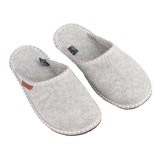 1. Natural felt slippers Halla by OmaKing in light grey, shown in a studio setting