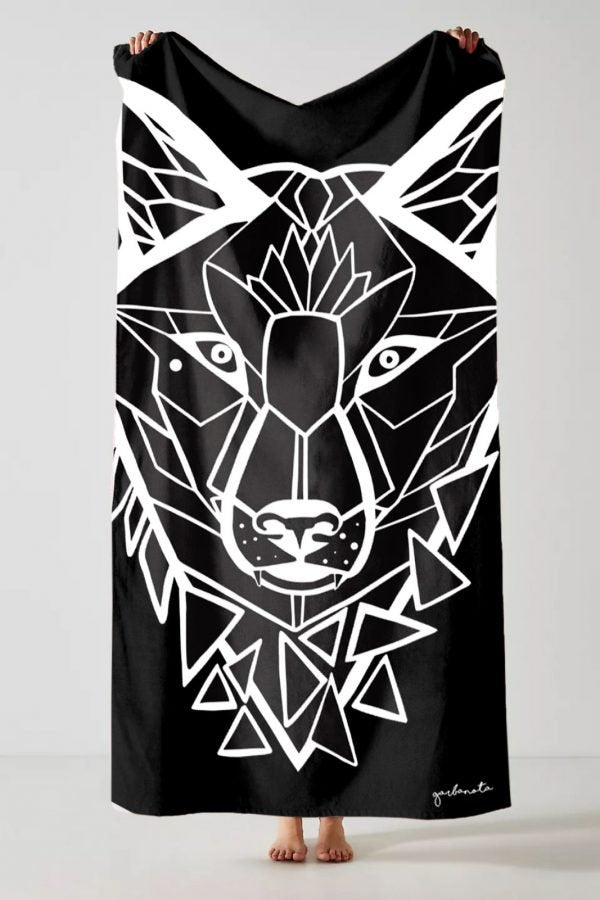 2. Studio shot of Garbanota Towel White Wolf in black, featuring geometric wolf design and brand signature