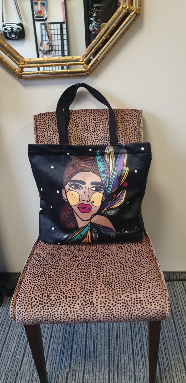 4. Garbanota HANDBAG LILY - COLORED with artistic print, displayed on a stylish chair