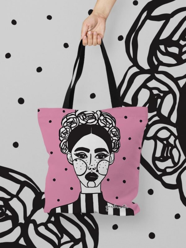 4. Garbanota HANDBAG MARGO in pink with graphic painting, held against artistic background