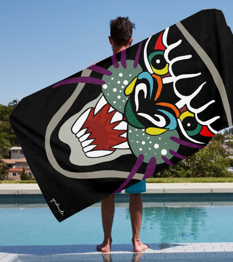 1. Garbanota Towel Pantera with hand-drawn panther design, held by male model by the pool