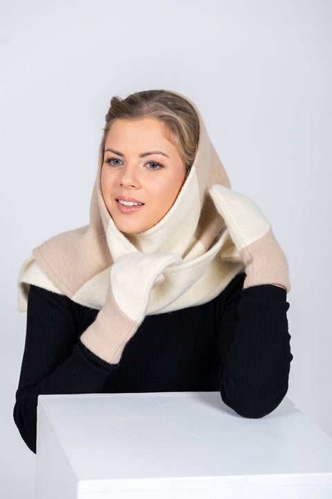 3. Women's HERTTA wool triangle shawl in white and beige, styled as a hood with a front view in a studio setting