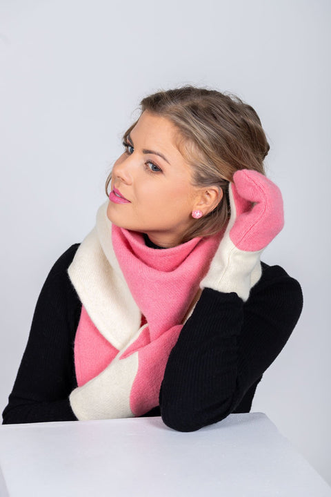 3. Woman styling HERTTA pink and white wool triangle shawl as a scarf with matching mittens, studio setting