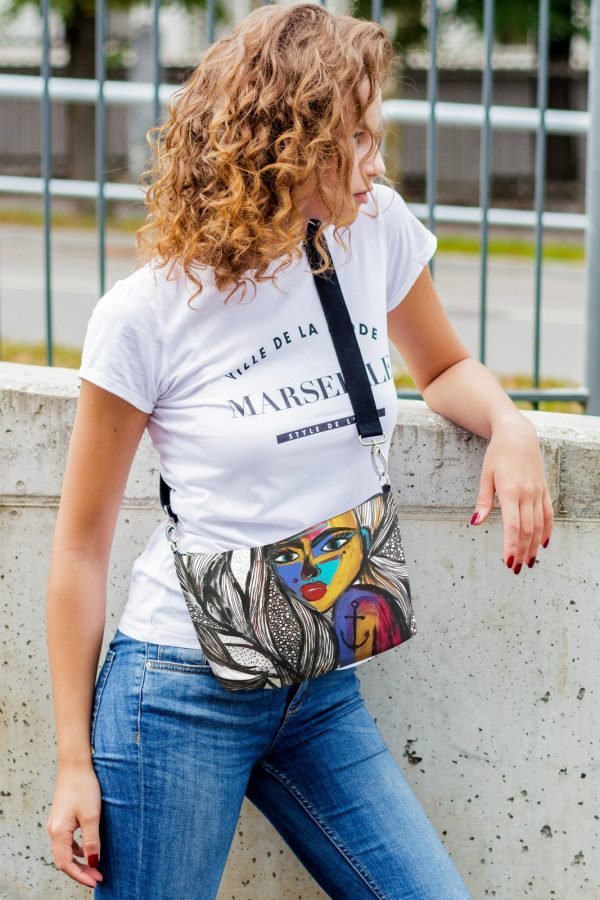 4. Women's shoulder bag with mermaid artwork by Dovilė Aleksonė, shown open with hand accessing interior