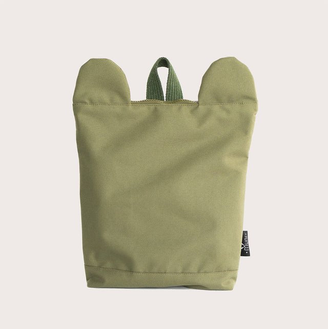4. Back view of Muni Green Bear Backpack in studio, showing adjustable straps and chest strap