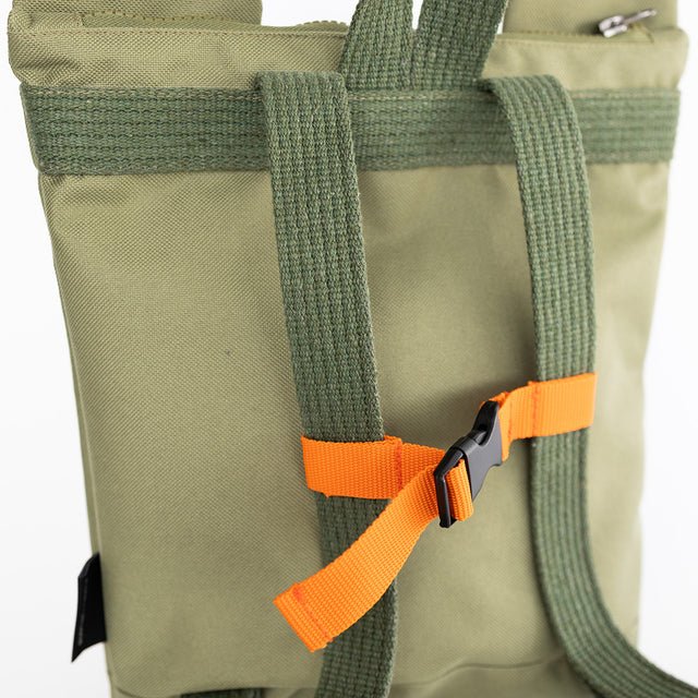 7. Muni Green Bear Backpack in studio with sunglasses hanging, emphasizing fun design