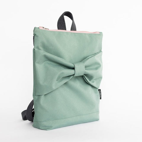 5. Side view of Muni kids mint bow backpack in studio, highlighting bow detail and pink zipper