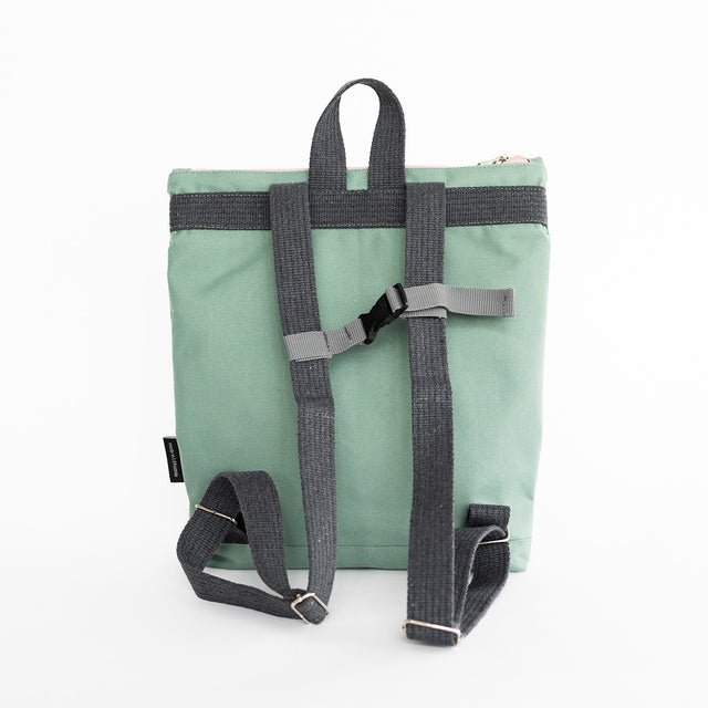 6. Back view of Muni kids mint bow backpack in studio, showing adjustable straps