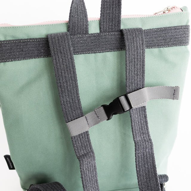 7. Close-up of Muni kids mint bow backpack straps and buckle in studio