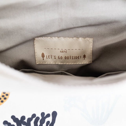 5. Interior view of Muni Corals backpack with 'Let's Go Outside!' label