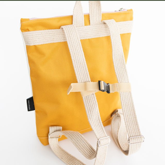 4. Close-up of adjustable straps on Muni kids backpack in yellow polyester