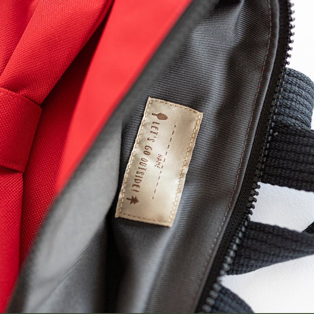 6. Interior view of Muni red bow kids backpack with label detail