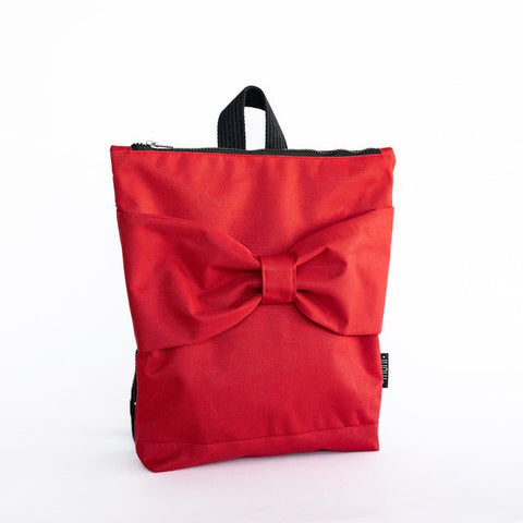 3. Front view of Muni red bow kids backpack, studio setting