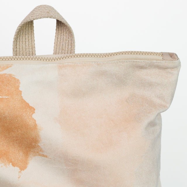 6. Close-up of Muni Abstract Beige backpack zipper and handle, showing velvet and polyester design