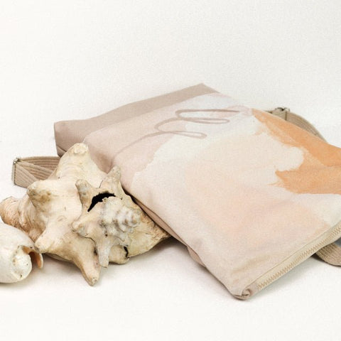 5. Flat lay of Muni Abstract Beige backpack with velvet and polyester design, styled with seashells