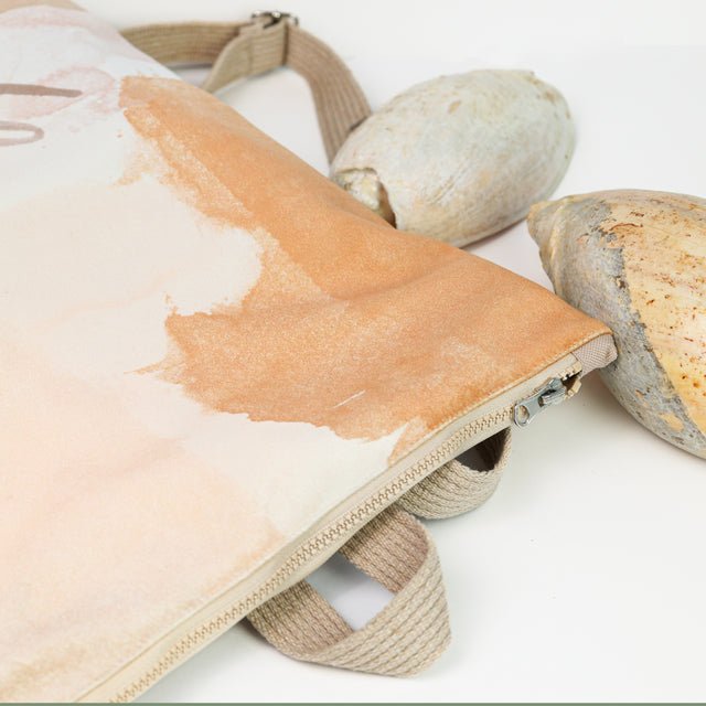 8. Close-up of Muni Abstract Beige backpack with velvet and polyester design, styled with seashells