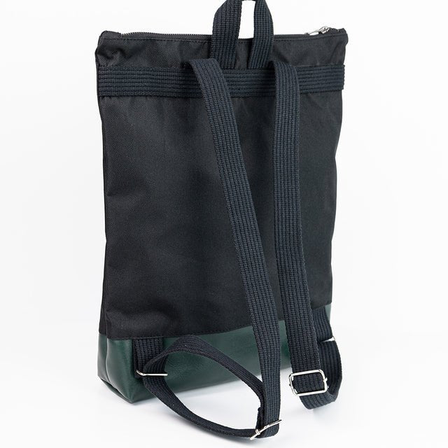 8. Back view of Muni waterproof backpack with green leather bottom, showing adjustable shoulder straps