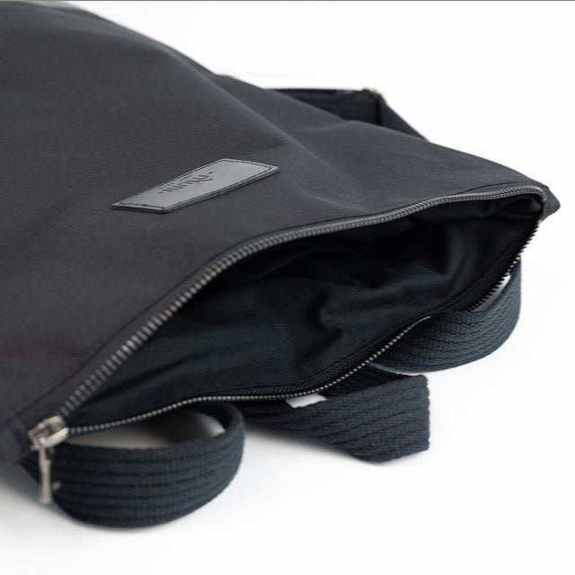 6. Close-up of Muni waterproof backpack showing zipper closure and black fabric lining