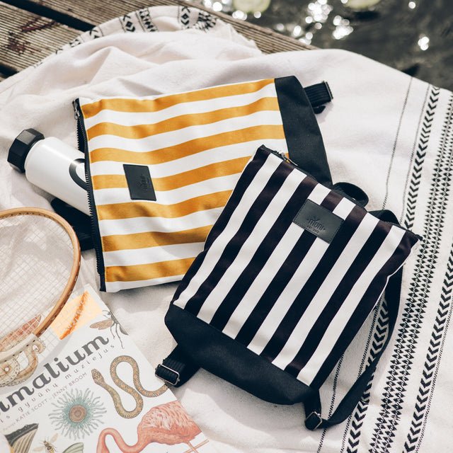 3. Muni black and white striped kids backpack with yellow striped bag in lifestyle setting