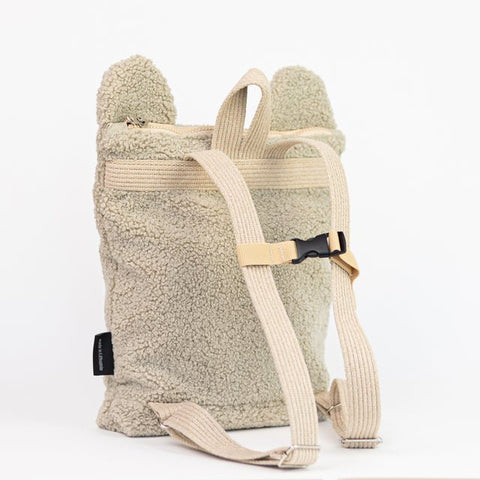 5. Muni beige teddy backpack showing adjustable shoulder straps and chest strap, side view