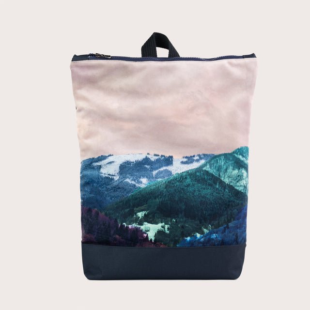 2. Front view of Muni Blue Mountains backpack with printed mountain design and navy bottom