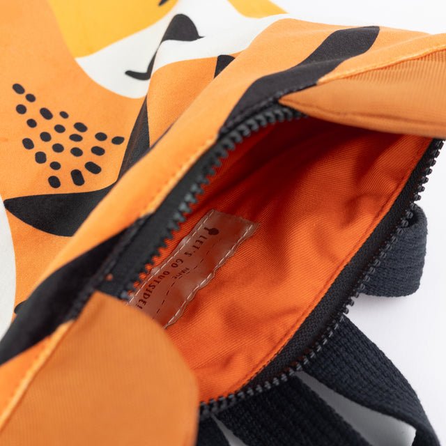 7. Close-up of Muni Tiger backpack zipper, showing interior lining and craftsmanship