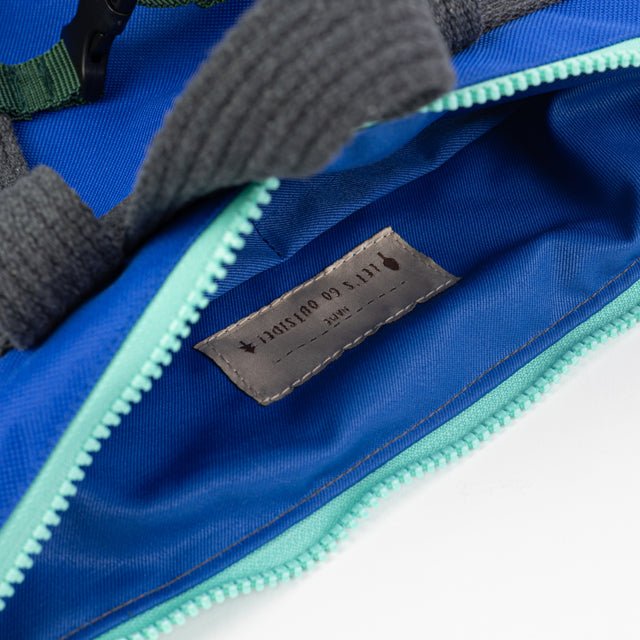 7. Interior view of Muni waterproof kids backpack, showing blue lining and label