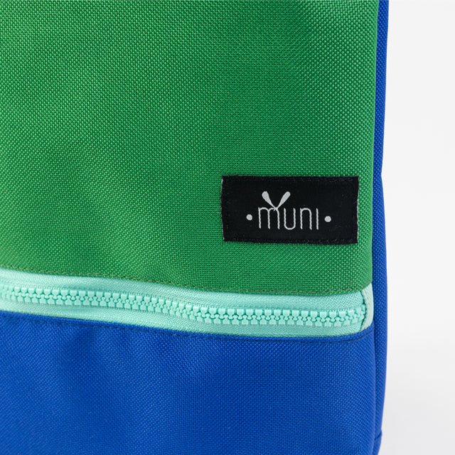 6. Close-up of Muni logo on green and blue waterproof kids backpack