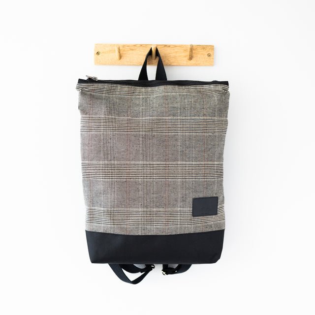 7. MUNI Tartan Backpack hanging, displaying full design and plaid pattern