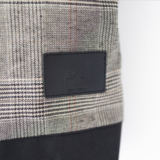 5. Close-up of MUNI logo on Tartan Backpack, showing detailed craftsmanship