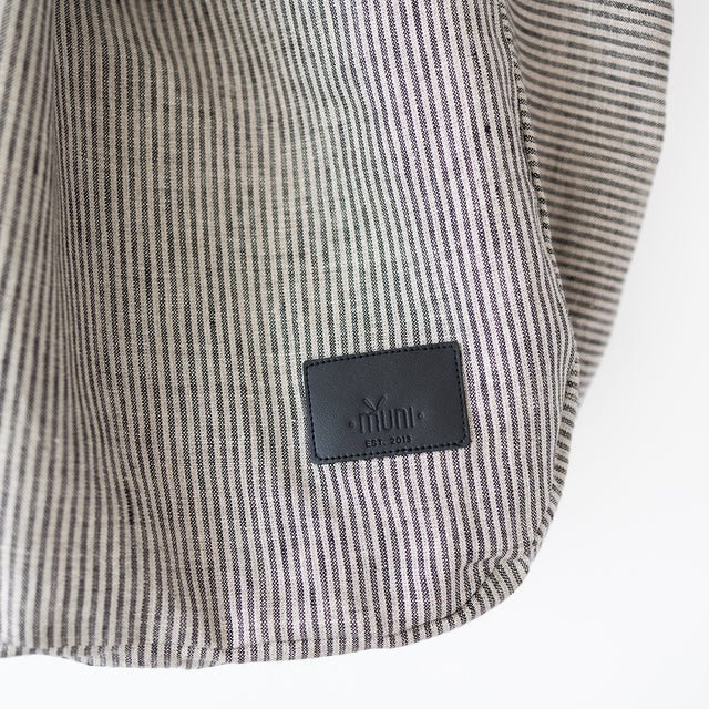8. Close-up of Muni logo on striped linen tote bag