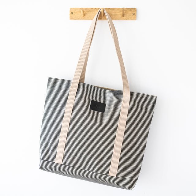 6. Muni striped denim tote bag hanging on wooden hook