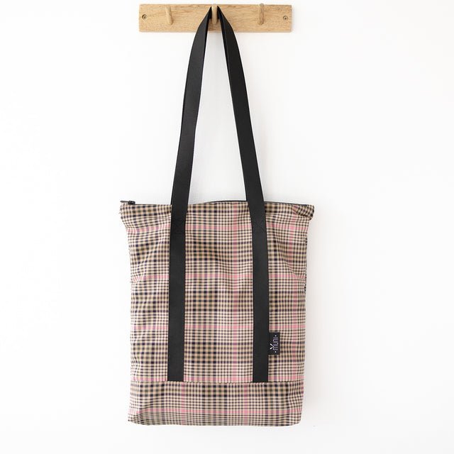 5. Studio shot of Muni tartan tote bag hanging, highlighting spacious design and black straps