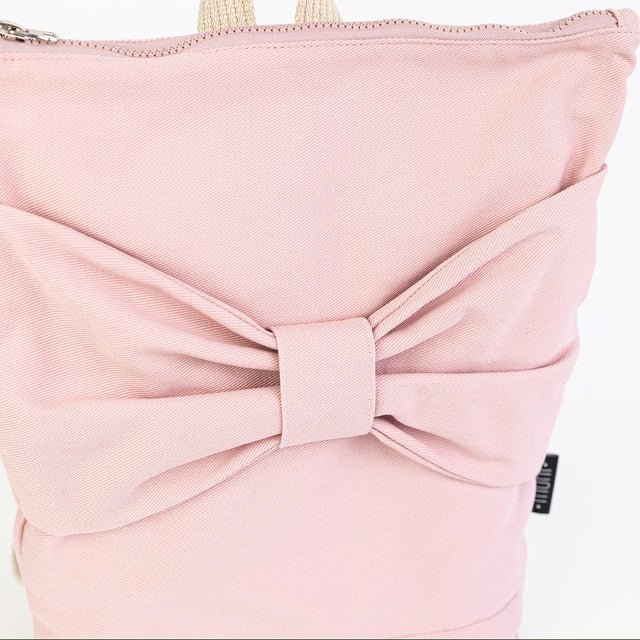 11. Close-up of Muni Pink Bow backpack, focusing on bow and pink denim texture