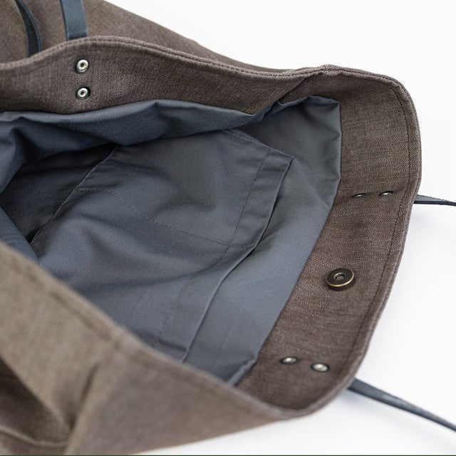 7. Interior view of Muni brown denim tote bag with grey cotton lining and slip pockets