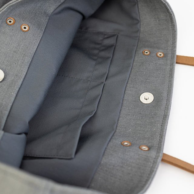8. Close-up of Muni grey denim tote bag interior, showing grey cotton lining and slip pockets