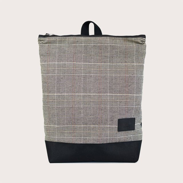 4. Studio image of MUNI Tartan Backpack, featuring plaid pattern and black bottom