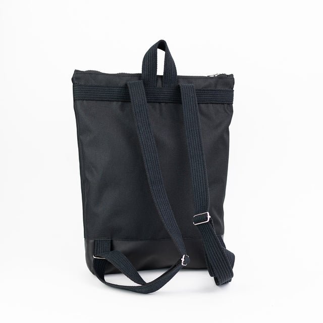 7. Back view of Muni black leather and polyester backpack, showing adjustable shoulder straps and sturdy design