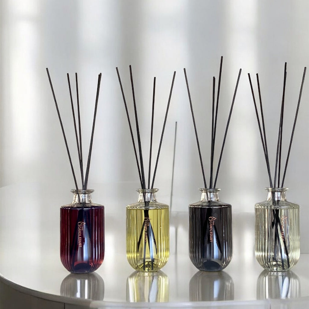 11. Four Candledust diffusers in various colors displayed on a white surface