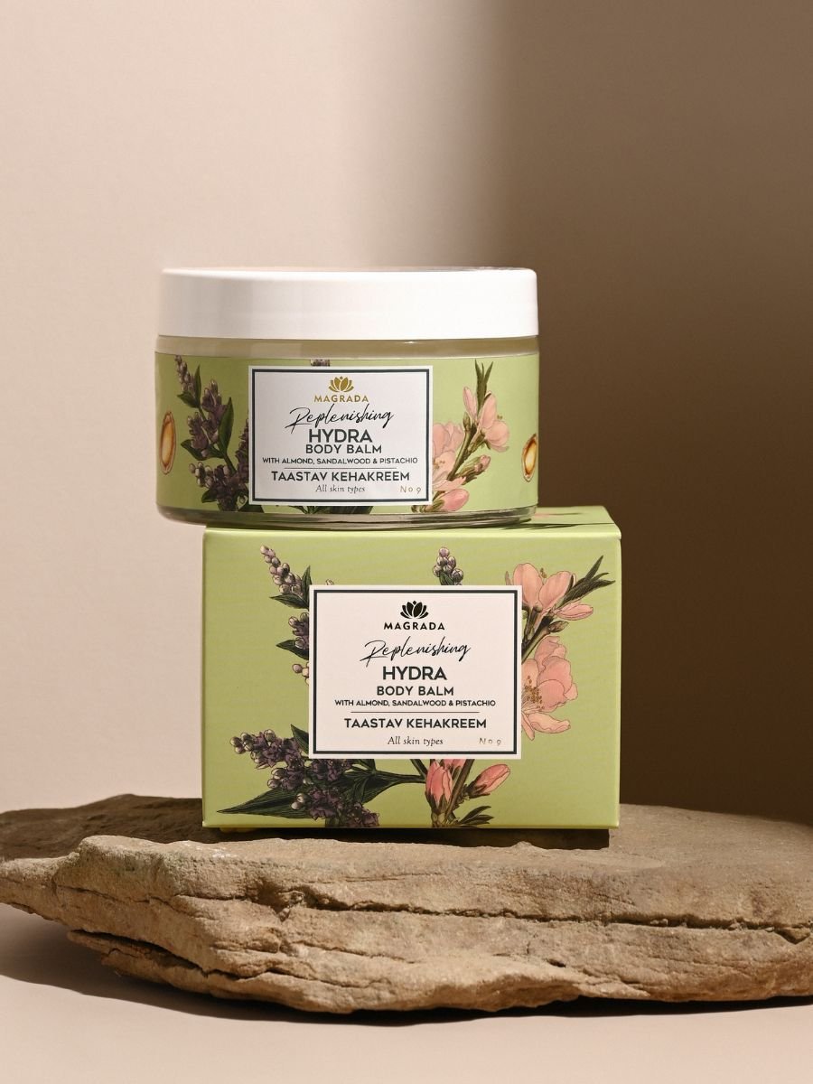 4. Magrada X Lauren Replenishing Body Balm jar and box with floral design on stone surface